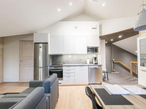 a kitchen with a couch and a table in a room at Holiday Home Levin stara a09 by Interhome in Levi