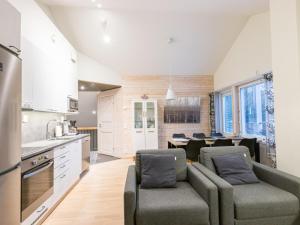 a kitchen and living room with a couch and a table at Holiday Home Levin stara a09 by Interhome in Levi +17 photos
