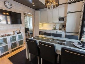 a kitchen with a table and chairs in a room at Holiday Home Levin stara a03 by Interhome in Levi
