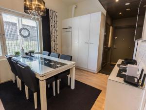 a kitchen with a dining table and chairs in a room at Holiday Home Levin stara a03 by Interhome in Levi
