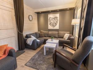 a living room with a couch and a table at Holiday Home Levin stara a03 by Interhome in Levi +18 photos