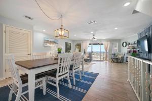 a dining room with a white table and chairs at Family Tides - Beachfront Pet-Friendly Duplex in Destin