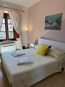 a bedroom with a large bed with two towels on it at At Home Bed and Breakfast in Lucca
