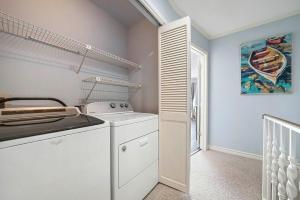 a white kitchen with a stove and a sink at Family Tides - Beachfront Pet-Friendly Duplex in Destin +48 photos