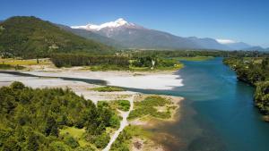 an aerial view of a river with a mountain in the background at Cabañas Jade in Cochamó
