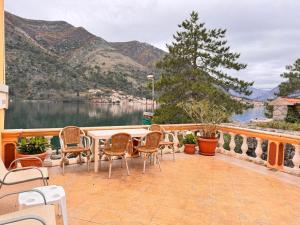 a patio with chairs and a view of a lake at Miramare Seaside Aparts in Kotor