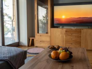 a bowl of fruit on a table in a living room at Pikk 45 in Otepää +10 photos