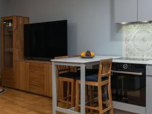 a kitchen with a table with a television on it at Pikk 45 in Otepää