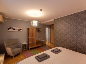 a room with a bed and a chair and a table at Pikk 45 in Otepää