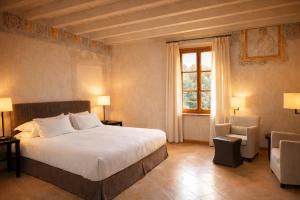 a bedroom with a large bed and a window at Villa Arcadio in Salò