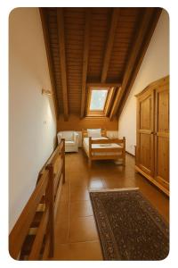 a living room with a couch and a table at SkiLift Tarvisio Apartment Free Parking in Tarvisio +10 photos