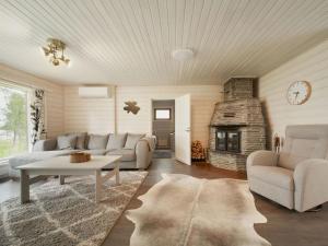 a living room with a couch and a fireplace at Holiday Home Jormakka by Interhome in Levi