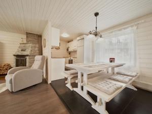 a kitchen and dining room with a table and chairs at Holiday Home Jormakka by Interhome in Levi