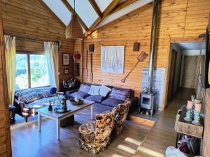 a living room with a couch and a table at Casa Bella Vista Futrono in Futrono