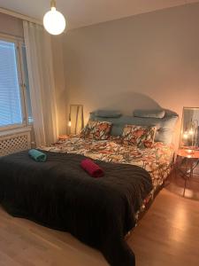 a bedroom with a large bed with two pillows at Great two bedrooms apartment with a private sauna and a sea view from the balcony close Helsinki center in Helsinki