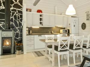 a kitchen with a table and chairs and a fireplace at Holiday Home Lapinvouti by Interhome in Levi