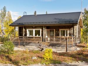 a wooden house with a black roof at Holiday Home Lapinvouti by Interhome in Levi