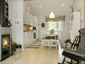 a kitchen and dining room with a fireplace and a table at Holiday Home Lapinvouti by Interhome in Levi +15 photos