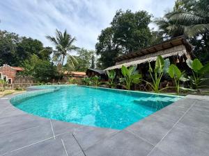 a swimming pool in front of a house at The Elephant Next-Door in Udawalawe +63 photos