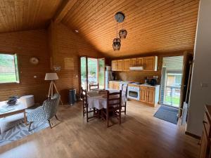 a kitchen with a table and chairs in a room at CHALET Cosy in Uxelles