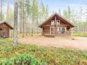 a cabin in the middle of a forest at Holiday Home Lumomarja by Interhome in Pyhätunturi