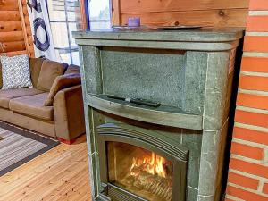 a fireplace in the corner of a living room at Holiday Home Lumomarja by Interhome in Pyhätunturi +10 photos