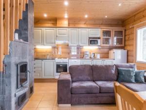 a living room with a couch and a kitchen at Holiday Home Kätkä by Interhome in Kotkasuvanto +14 photos