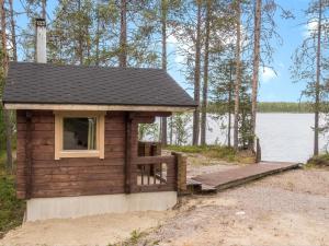 a small cabin on the shore of a lake at Holiday Home Kätkä by Interhome in Kotkasuvanto