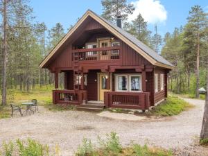 a cabin in the woods with a picnic table in front of it at Holiday Home Kätkä by Interhome in Kotkasuvanto