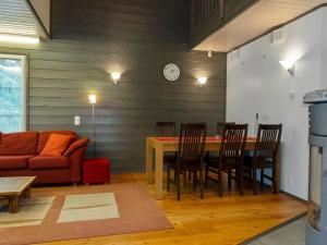 a living room with a table and a couch at Holiday Home Pulkka 1 by Interhome in Salla