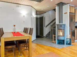 a living room with a fireplace and a dining room table at Holiday Home Pulkka 1 by Interhome in Salla