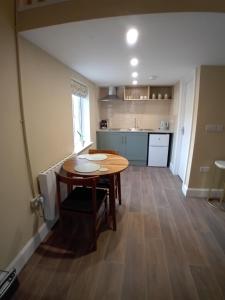 a kitchen with a wooden table in a room at River View at Silver River in Cadamstown