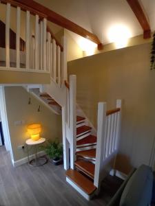 a spiral staircase in a house with a lamp at River View at Silver River in Cadamstown