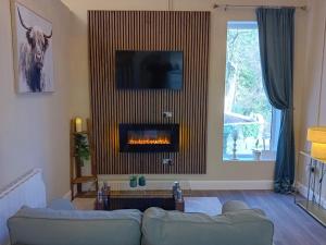 a living room with a couch and a fireplace at River View at Silver River in Cadamstown