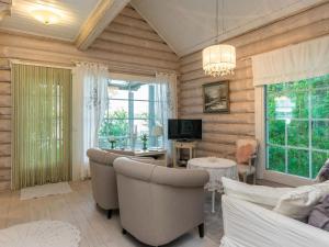 a living room with a couch and chairs and a television at Holiday Home Torniniemi by Interhome in Hiukkajoki +23 photos