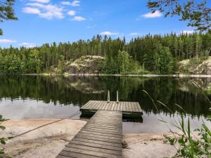 a dock in the middle of a lake at Holiday Home Lahukka by Interhome in Hurissalo