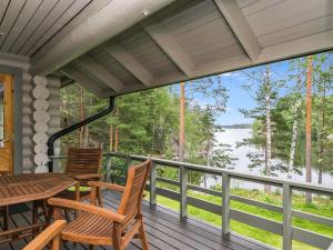 a porch with a table and chairs and a view of the water at Holiday Home Lahukka by Interhome in Hurissalo