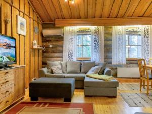 a living room with a couch and a tv at Holiday Home Luppokero 1 by Interhome in Pyhätunturi