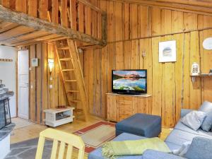 a living room with a couch and a tv at Holiday Home Luppokero 1 by Interhome in Pyhätunturi