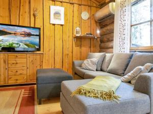 a living room with a couch and a tv at Holiday Home Luppokero 1 by Interhome in Pyhätunturi