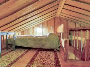 a bedroom with a bed in a room with wooden walls at Holiday Home Luppokero 1 by Interhome in Pyhätunturi +4 photos