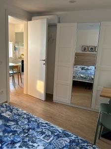 a room with a mirror and a bedroom with a bed at Finestre sul mare in Framura