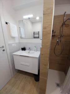 a white bathroom with a sink and a shower at Finestre sul mare in Framura +19 photos