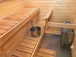 a inside of a sauna with a bucket in it at Holiday Home Point vale 3 by Interhome in Tahkovuori +3 photos