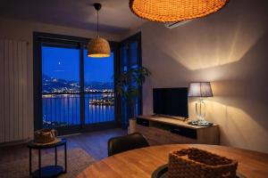 a living room with a table and a large window at Il Sogno terrazza panoramica in Massino Visconti