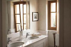 a bathroom with two sinks and a mirror at Villa Arcadio in Salò +53 photos