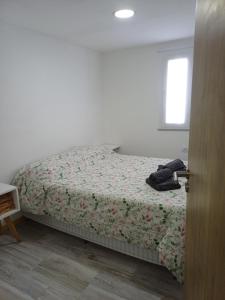 a bedroom with a bed with a floral bedspread at Dorado Stey 2 in Río Grande