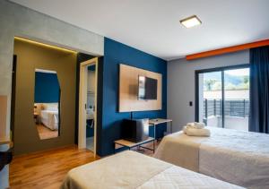 a bedroom with two beds and a mirror at Minas Garden Hotel in Poços de Caldas +59 photos