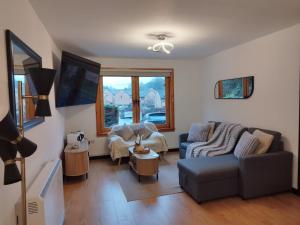 a living room with a couch and a table at Dundee Beach Villa with Free Parking in Dundee