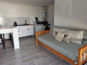 a living room with a couch and a kitchen at Dorado Stey 2 in Río Grande